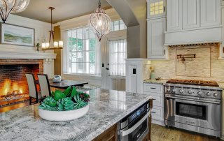 Modern kitchen with massive fireplace in Aurora, IL Victorian home.