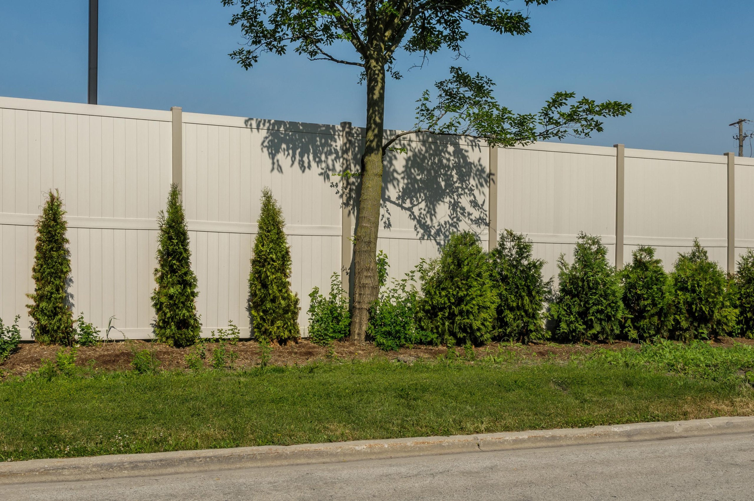 10' Rainer vinyl fence photo fence-13 installed around warehouse in River Grove, Illinois