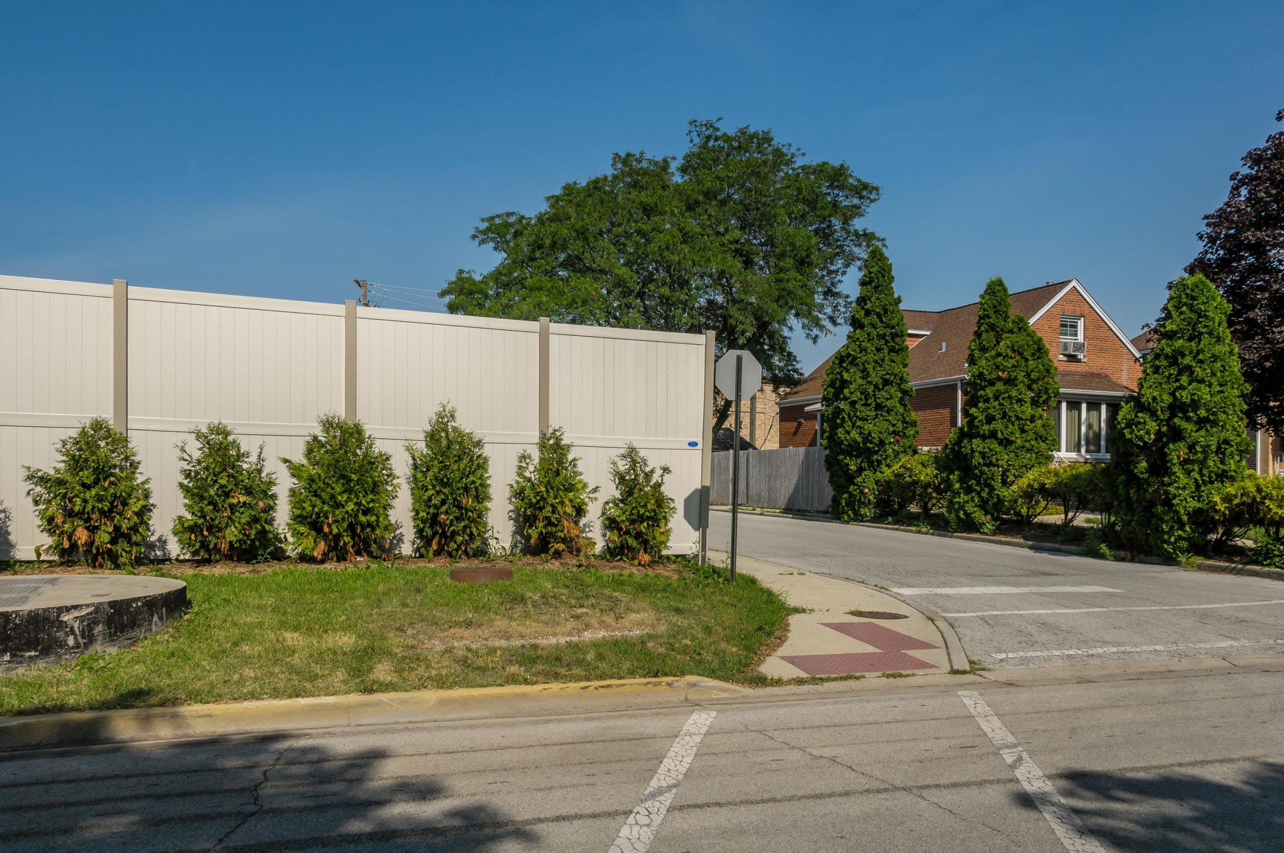 10' Rainer vinyl fence photo fence-8 installed around warehouse in River Grove, Illinois